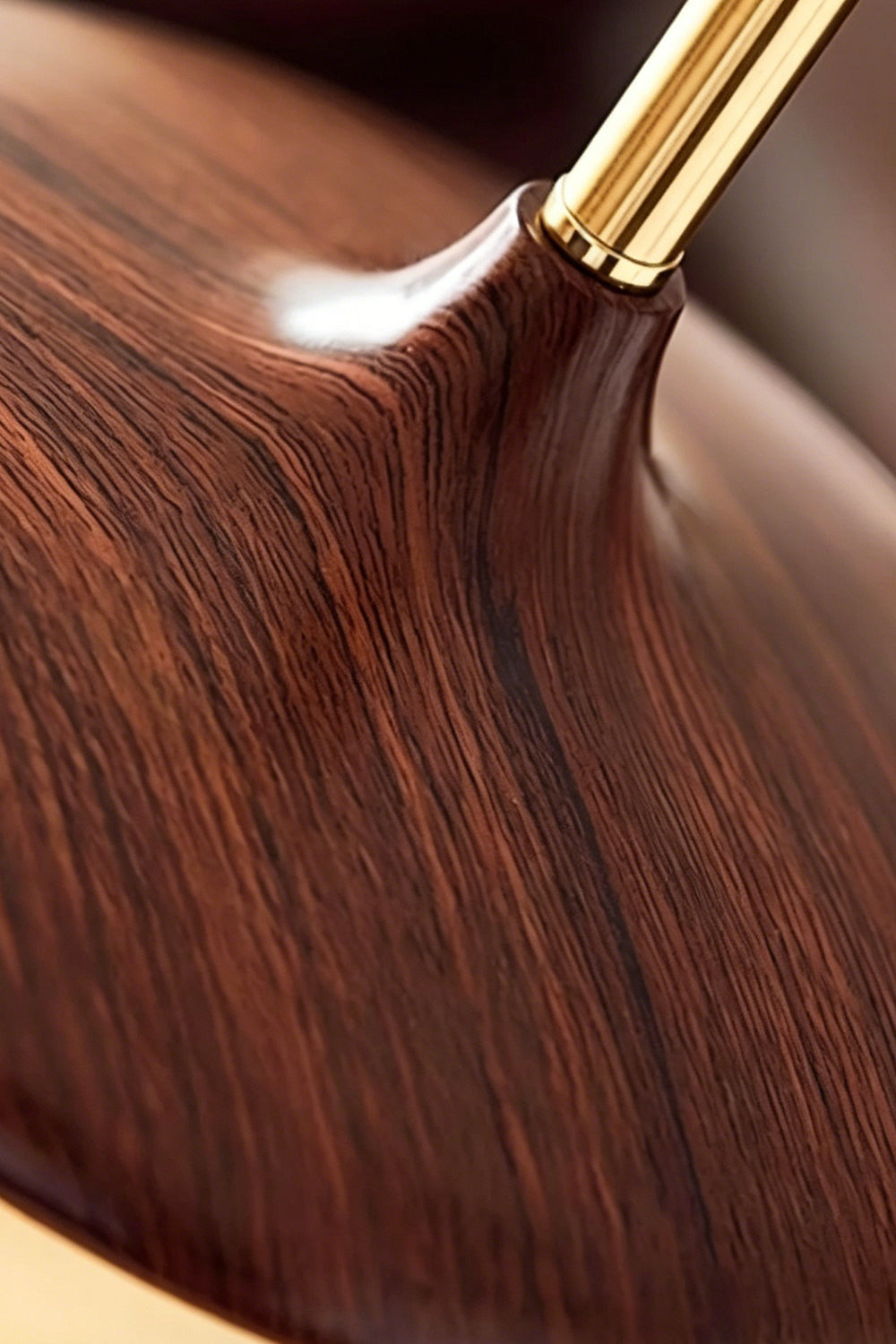 Soren Wood Grain Pendant Lamp | Wood, Glass, Metal | Extreme close-up showing the rich, smooth polished dark walnut wood grain texture and brass neck connection | Detail shot | Samu Lamp