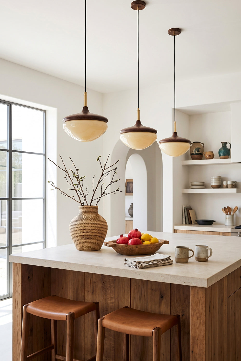 Soren Wood Grain Pendant Lamp | Wood, Glass, Metal | A trio of wood and glass pendant lamps casting a warm glow over a rustic wooden kitchen island | Samu Lamp