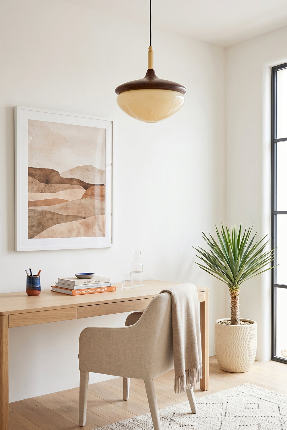 Soren Wood Grain Pendant Lamp | Wood, Glass, Metal | Suspended over a minimalist light wood writing desk with a cream chair and desert art frame | Samu Lamp