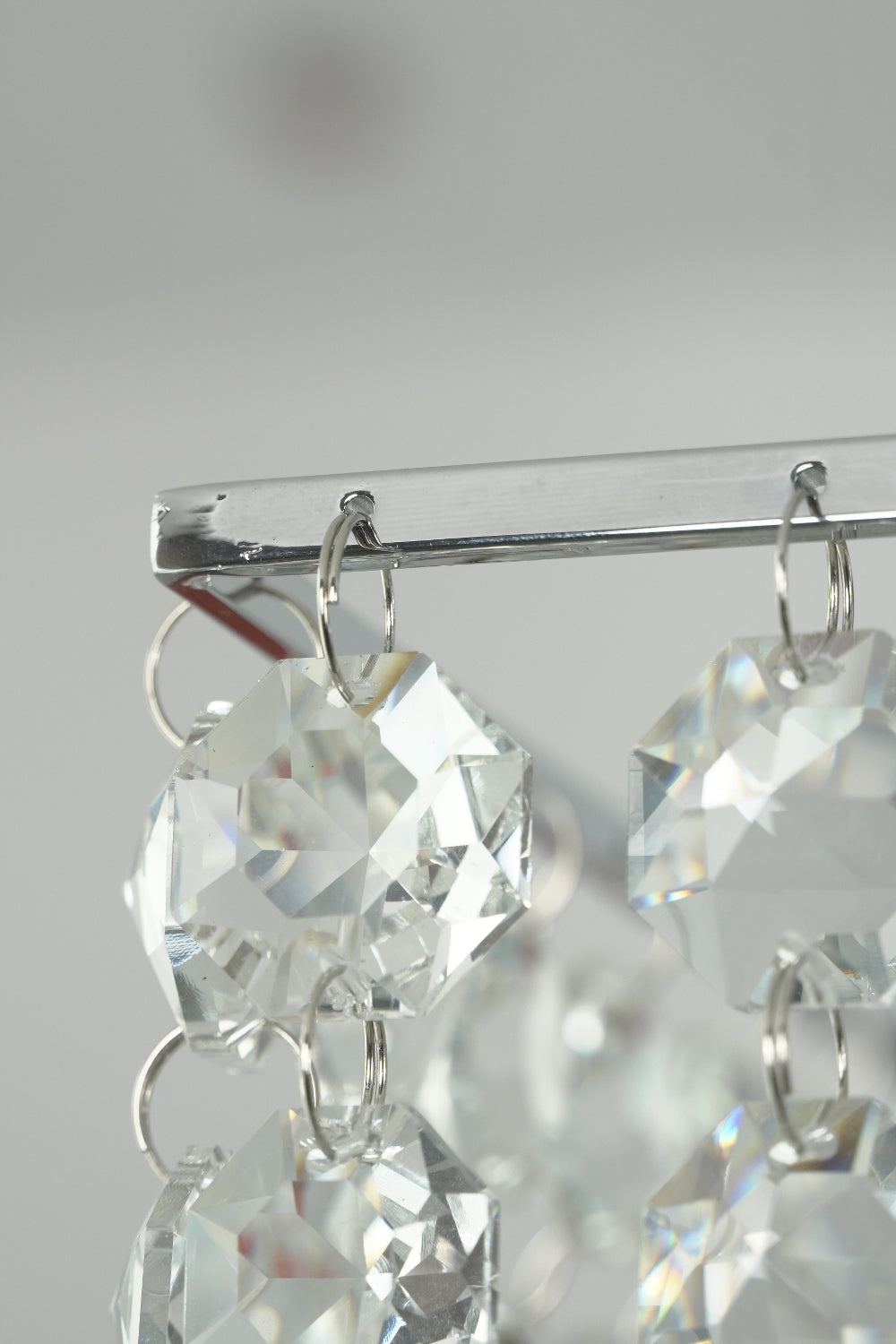 Corner detail of stainless steel chandelier frame | Stainless Steel, Crystal | Close-up showing the crystal attachments | Samu Lamp