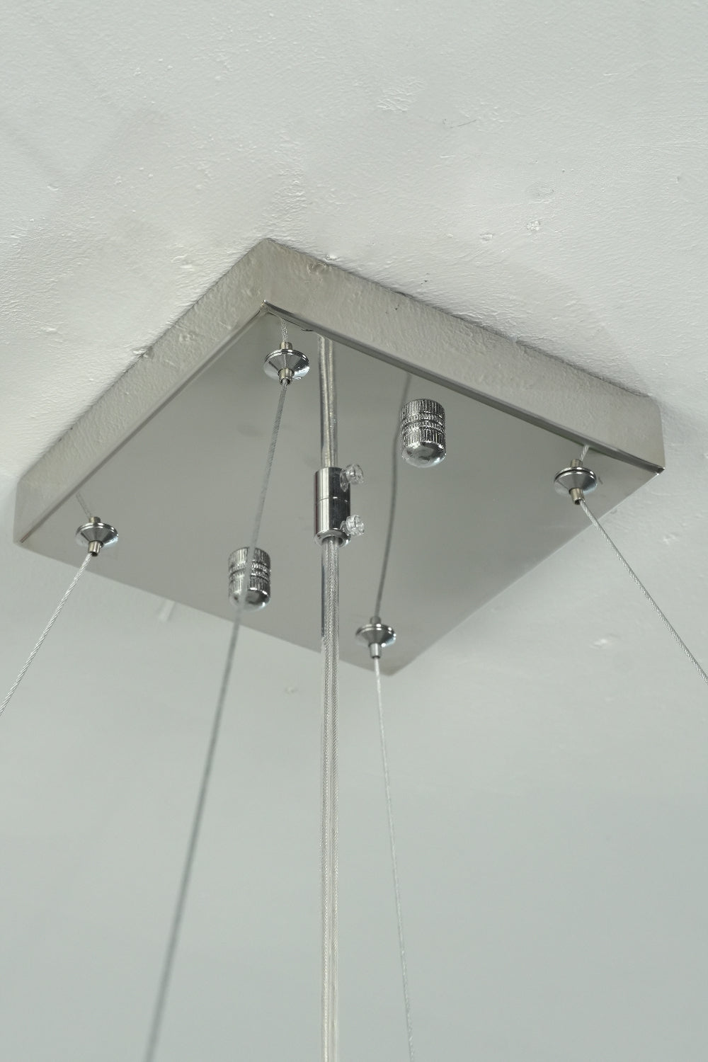 Square stainless steel ceiling canopy and hanging wires | Stainless Steel | Close-up of the mounting hardware for the chandelier | Samu Lamp