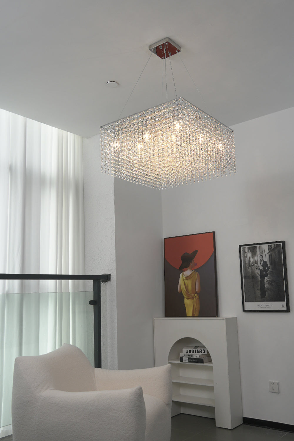 Modern crystal chandelier in a high-ceiling living area | Stainless Steel, Crystal | Interior scene with contemporary art and white furniture | Samu Lamp