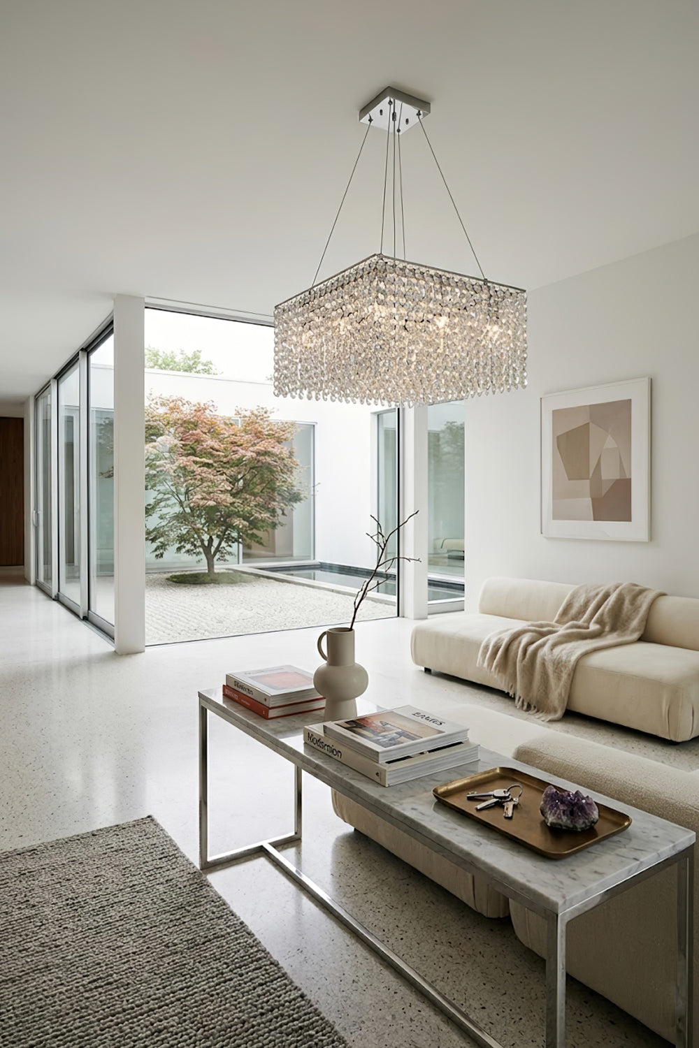 Sparkling crystal chandelier in an open-plan lounge | Stainless Steel, Crystal | Bright interior scene with large sliding glass doors | Samu Lamp