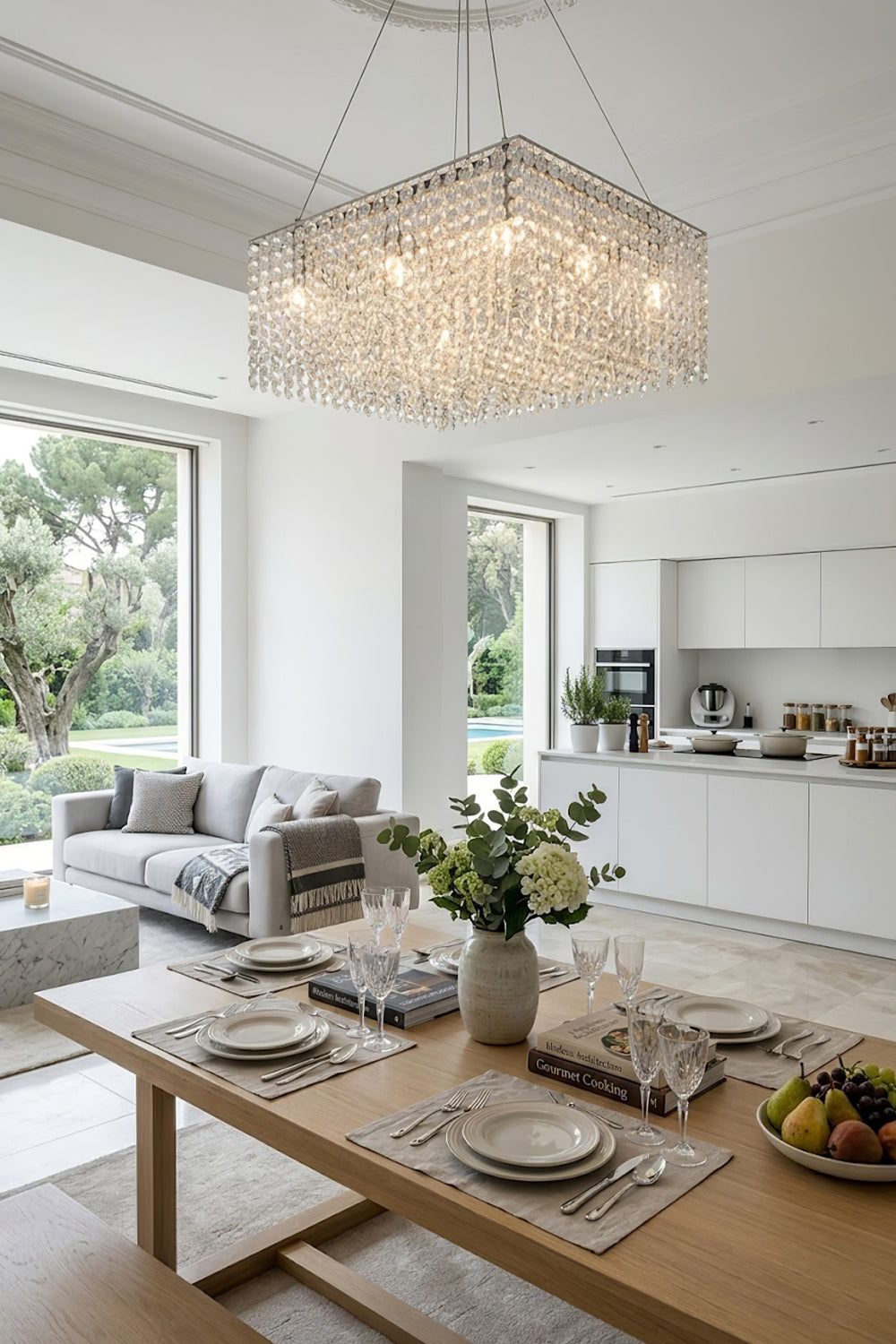 Modern rectangular crystal light over a wooden dining set | Stainless Steel, Crystal | Bright kitchen-dining area with white cabinetry | Samu Lamp