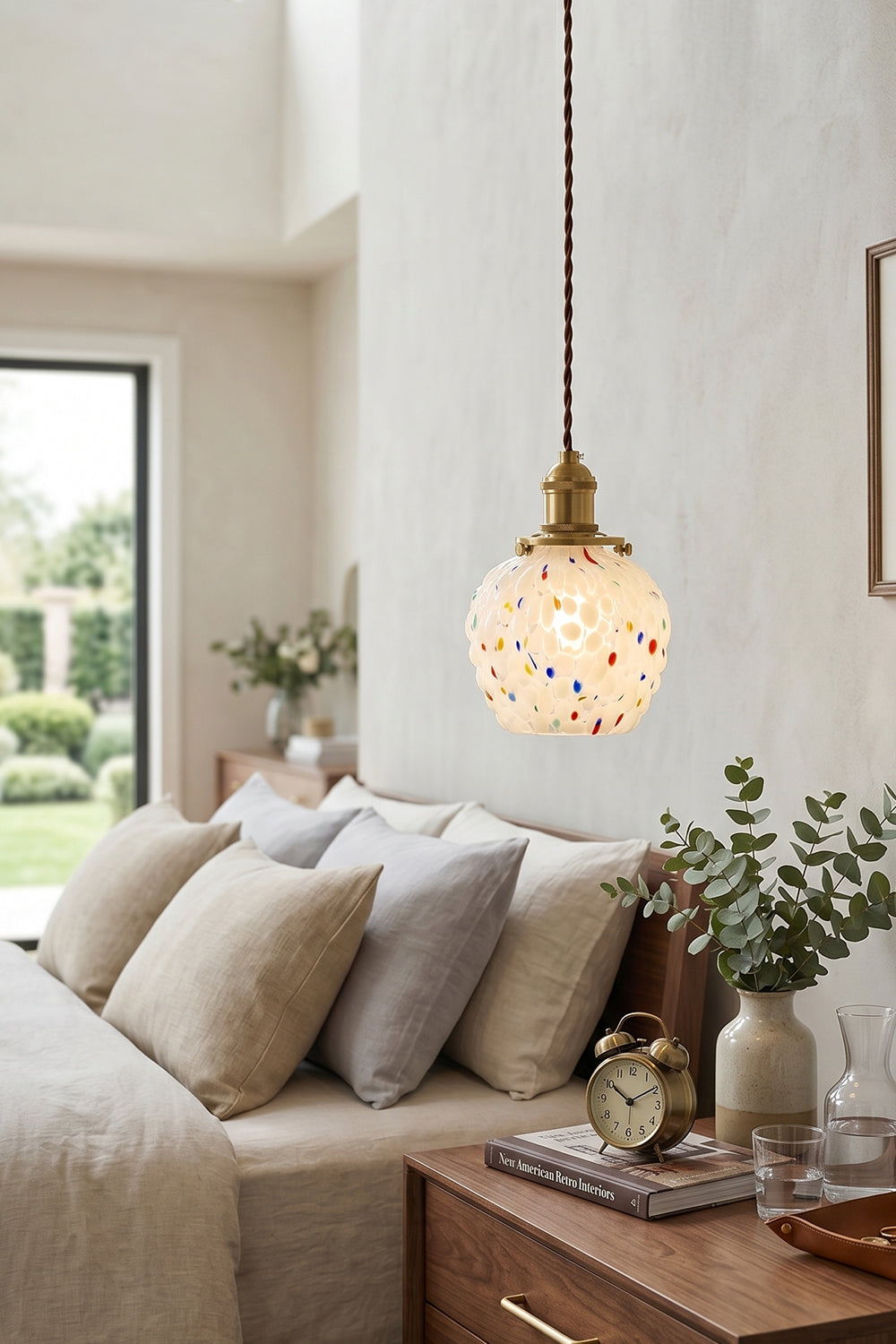 Speckled Bubble Glass Pendant Lamp | Glass, Metal | Hanging as a cozy bedside reading lamp over a wooden nightstand in a soft, cream-toned modern bedroom | Samu Lamp