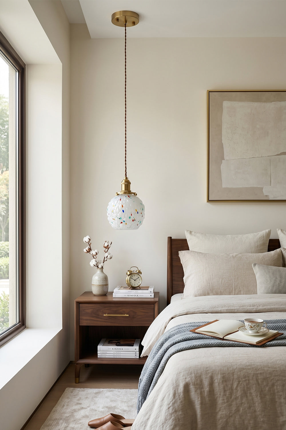 Speckled Bubble Glass Pendant Lamp | Glass, Metal | Positioned near a large bedroom window, providing soft light over a dark wood bedside table | Samu Lamp