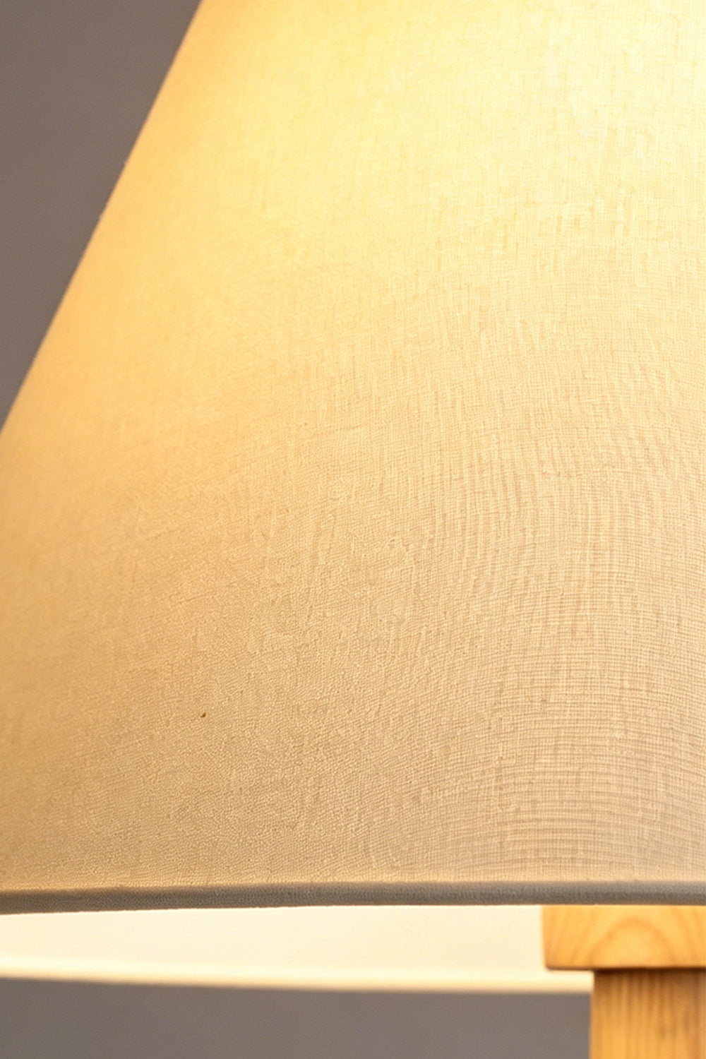 Sphaerica Lignum Wood Floor Lamp | Metal, Wood, Fabric | Macro shot of the textured beige fabric lampshade with a warm internal glow | Close-up | Samu Lamp