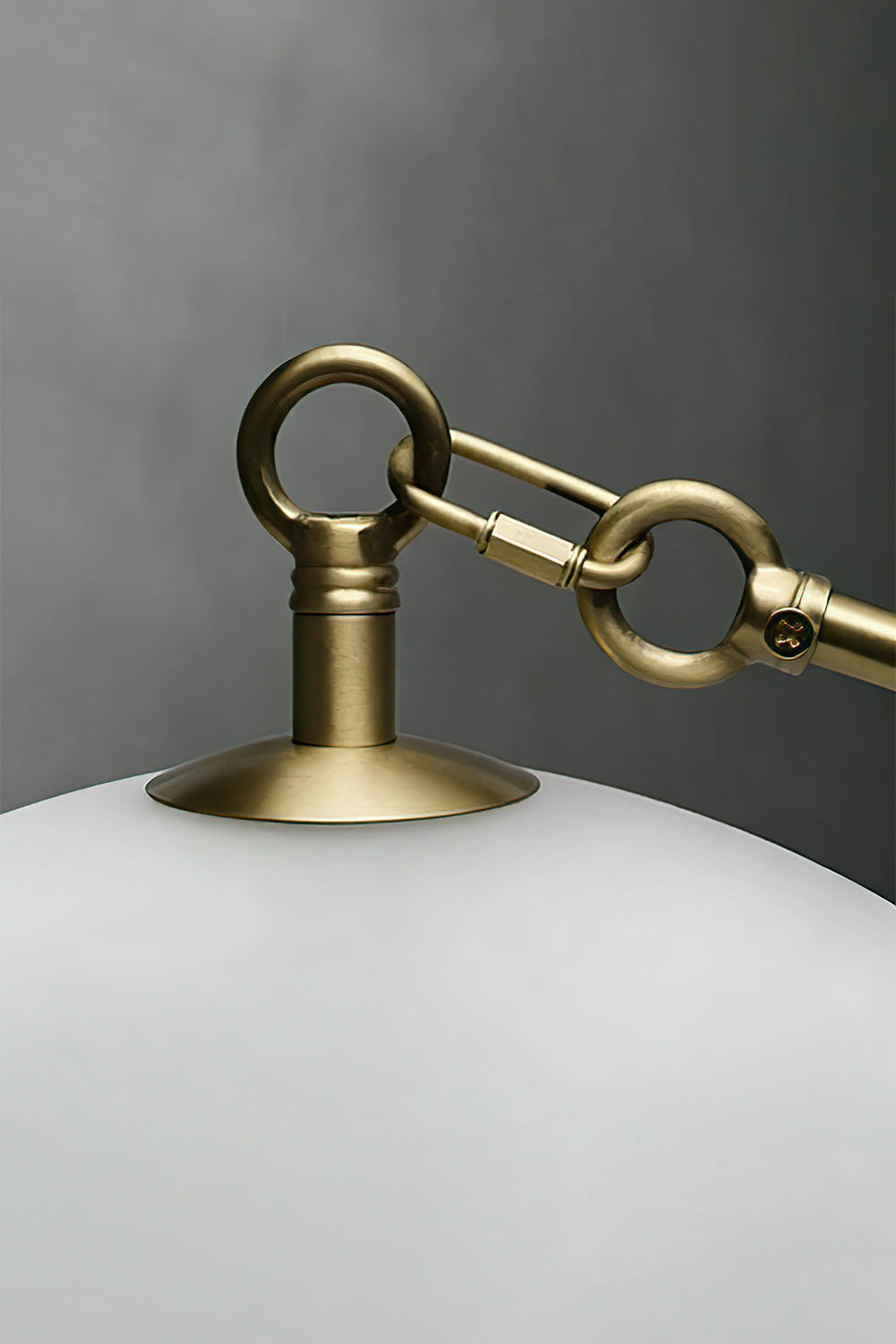 Detailed shot of brass hook and glass attachment | Metal, Glass | Showing the gold-finish hardware connection | Samu Lamp
