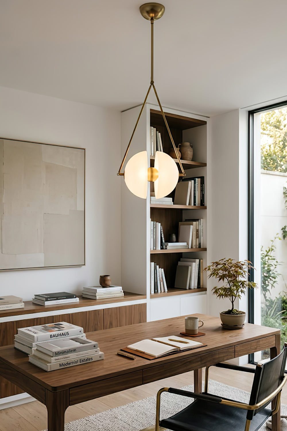 Split hemisphere oyster glass pendant | Metal, Glass | Centered in a home library over a large desk | Samu Lamp