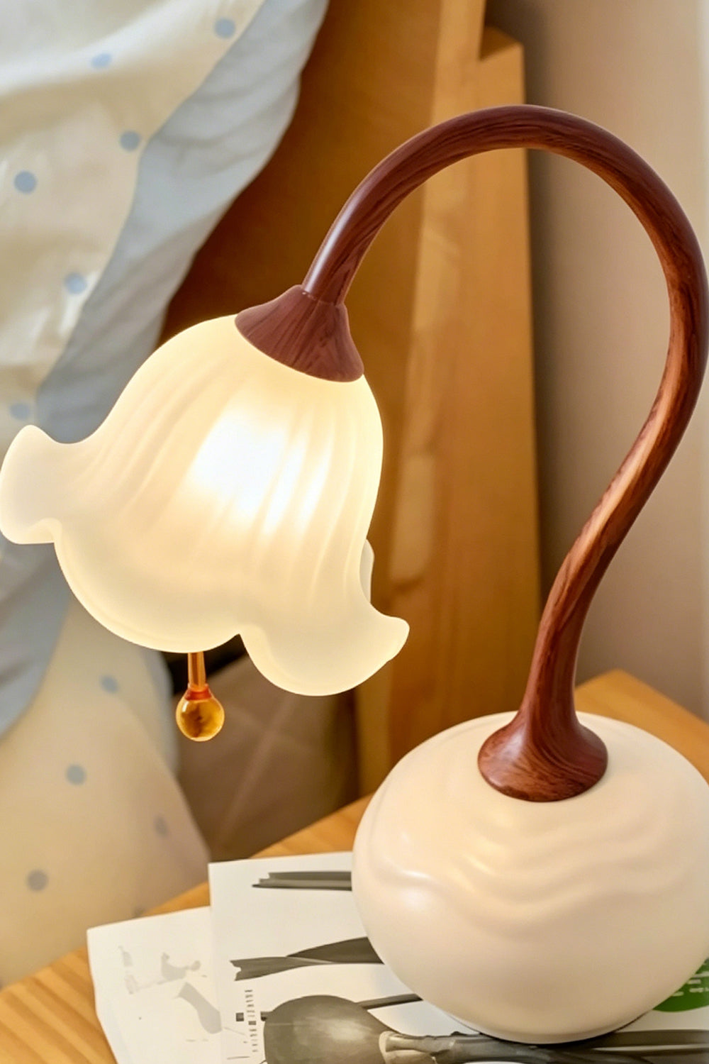 Lit Sylva Bloom lamp on a bedside nightstand | Resin, Glass | Samu Lamp