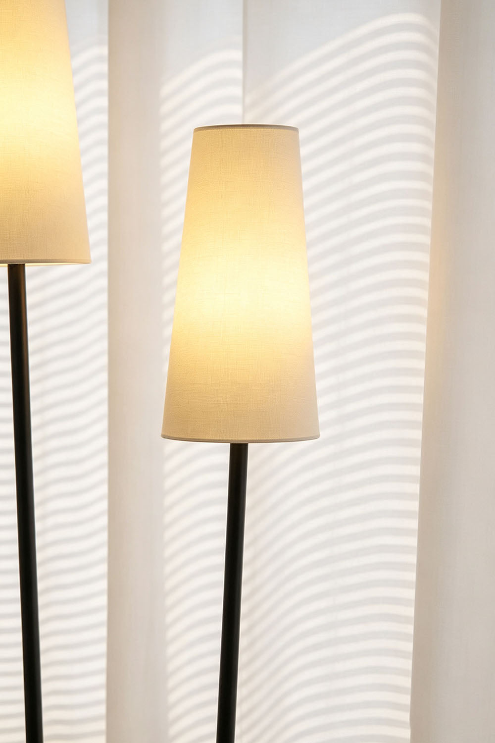 Sylva Branching Linen Shade Floor Lamp with soft light illuminating a room, placed near elegant sheer curtains.