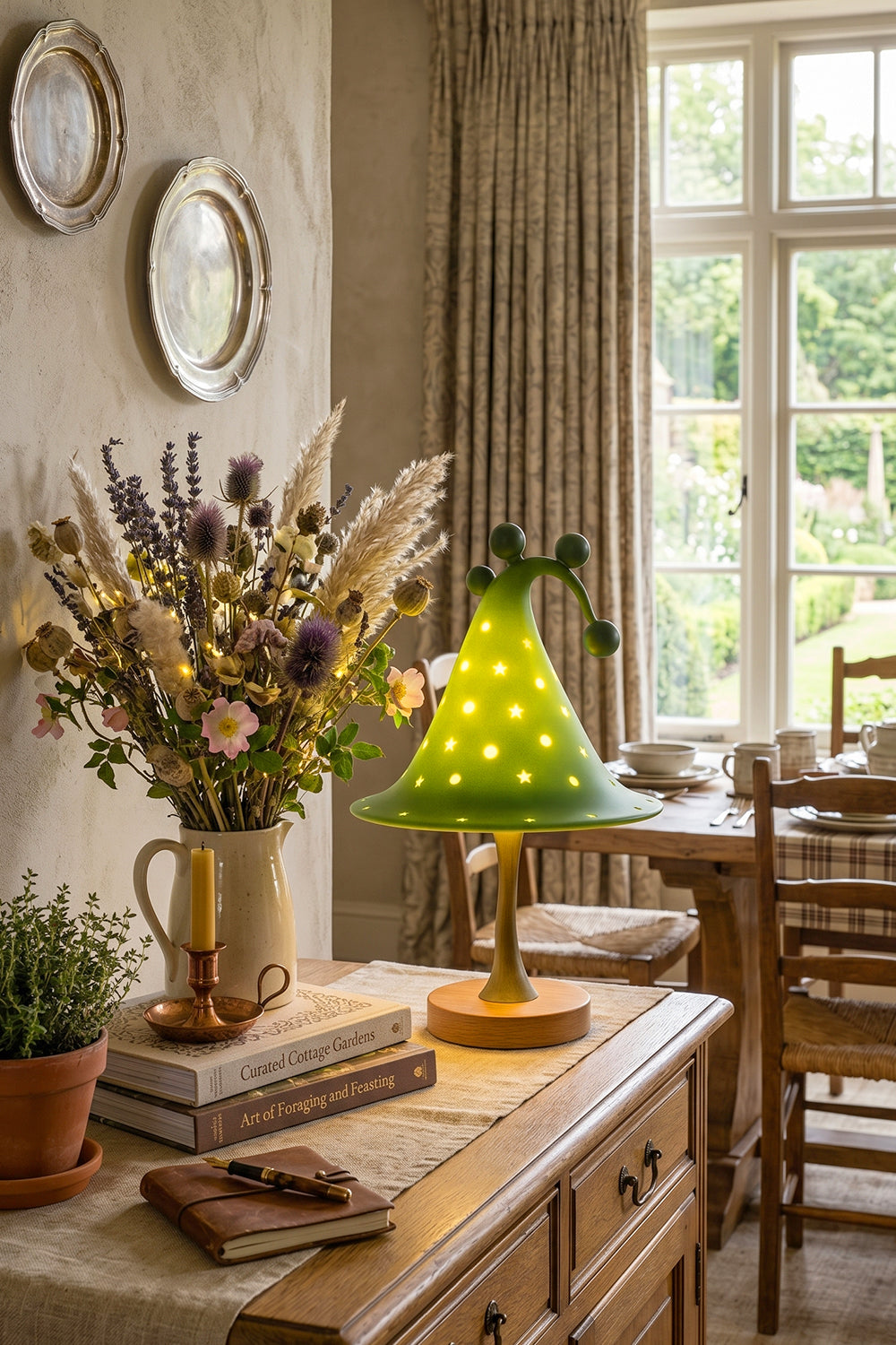 Sylvan Astral Resin Table Lamp | Green star pattern shade | Lit dining room scene | Sideboard display | Surrounded by plants | Samu Lamp
