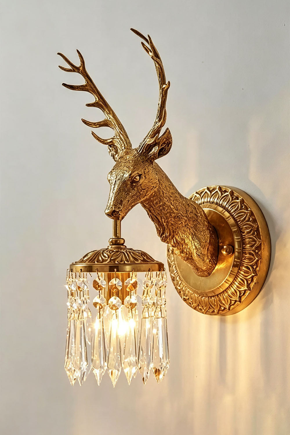 Sylvestre Cast Brass Stag Wall Sconce | Cast Brass and Crystal | Side profile view casting elegant shadows on a bright wall | Samu Lamp