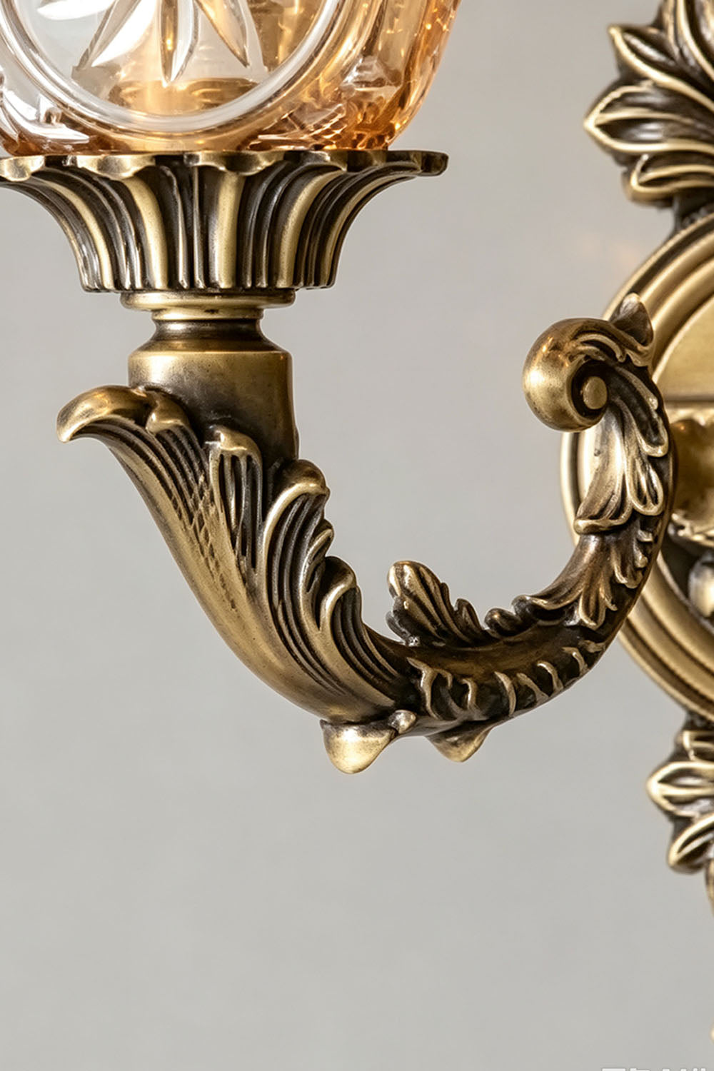 Detail view of the ornate design of the Sylvestre Petal Glass Brass Wall Lamp showcasing the brass finish.