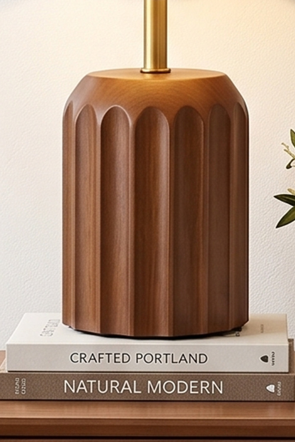 Tallulah Ribbed Wood Table Lamp | Wood, Fabric, Brass | Detailed close-up shot of the fluted brown wooden base resting on stacked design books | Samu Lamp