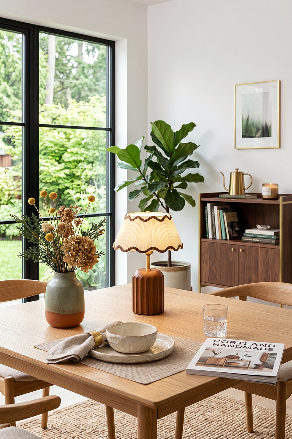 Tallulah Ribbed Wood Table Lamp | Wood, Fabric, Brass | Positioned as a decorative centerpiece on a wooden dining table surrounded by chairs and indoor plants | Samu Lamp