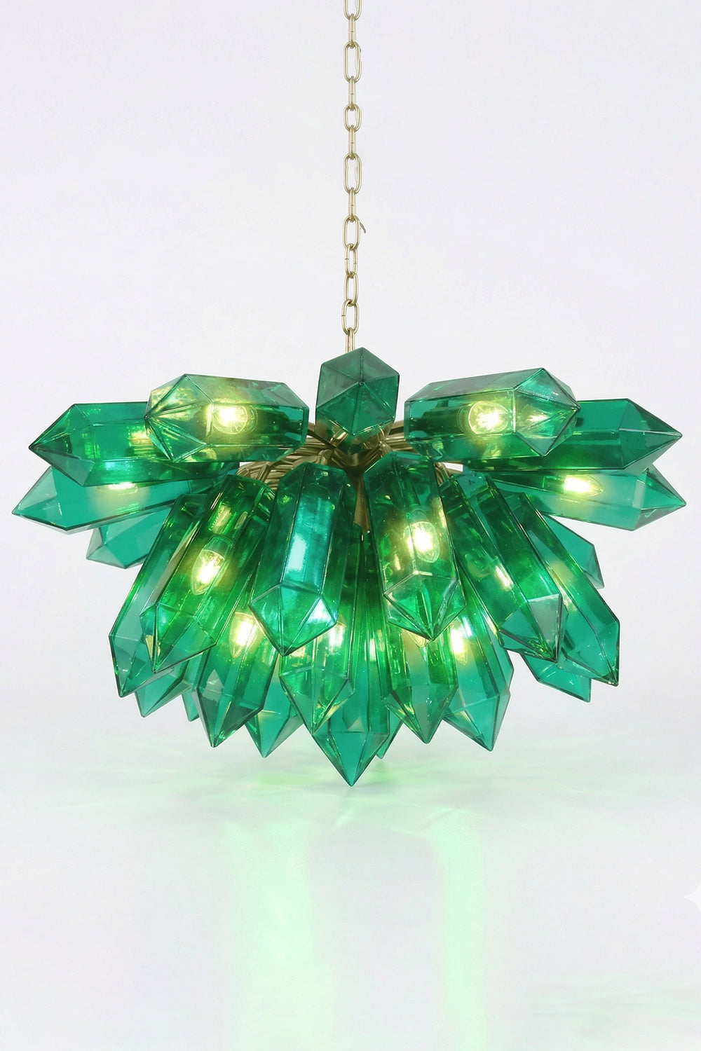 Lit teal prism cluster chandelier showing green glow | Metal | Glass | Front view with internal lights on white background | Samu Lamp