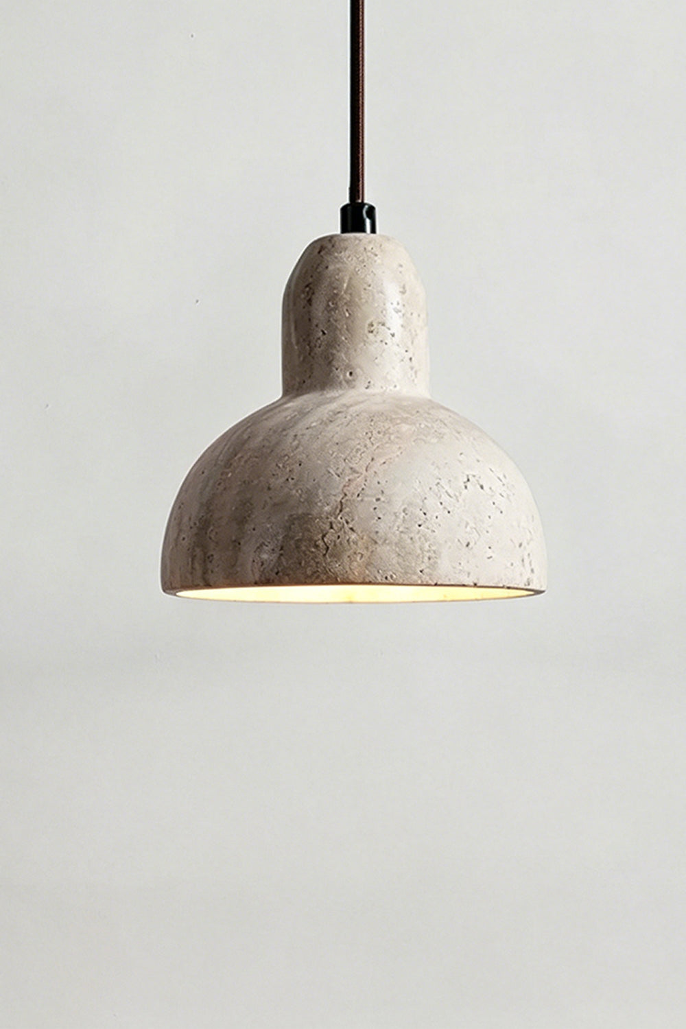 Lit Beige Travertine Pendant Light | Beige Travertine, Metal, Glass | Close-up showing warm upward and downward glow | Samu Lamp