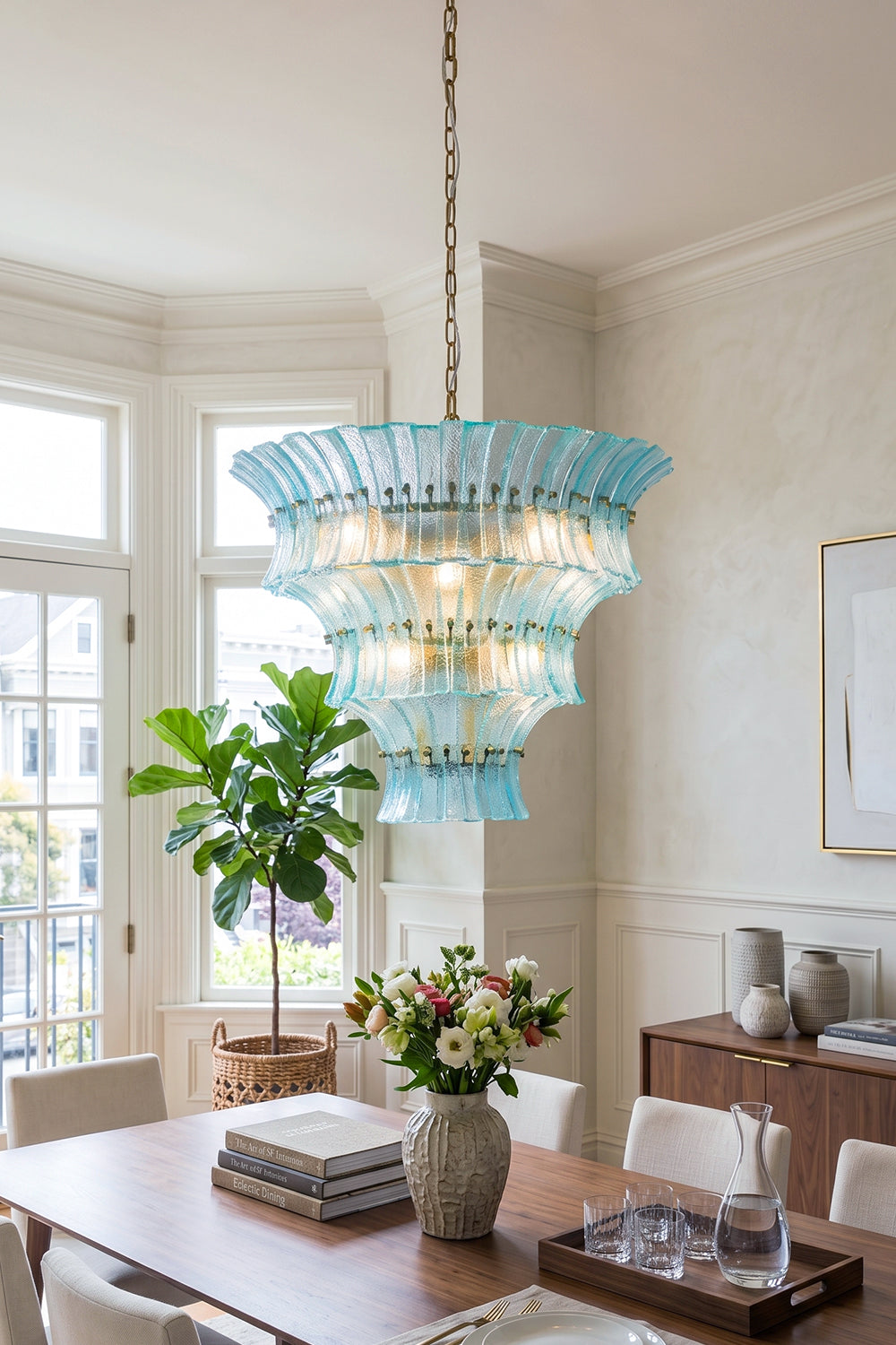 Thalassa Aquamarine Textured Glass Chandelier | Glass, Metal | Staged over a minimalist wooden table set with fresh flowers in a sunlit open-plan contemporary dining area | Samu Lamp