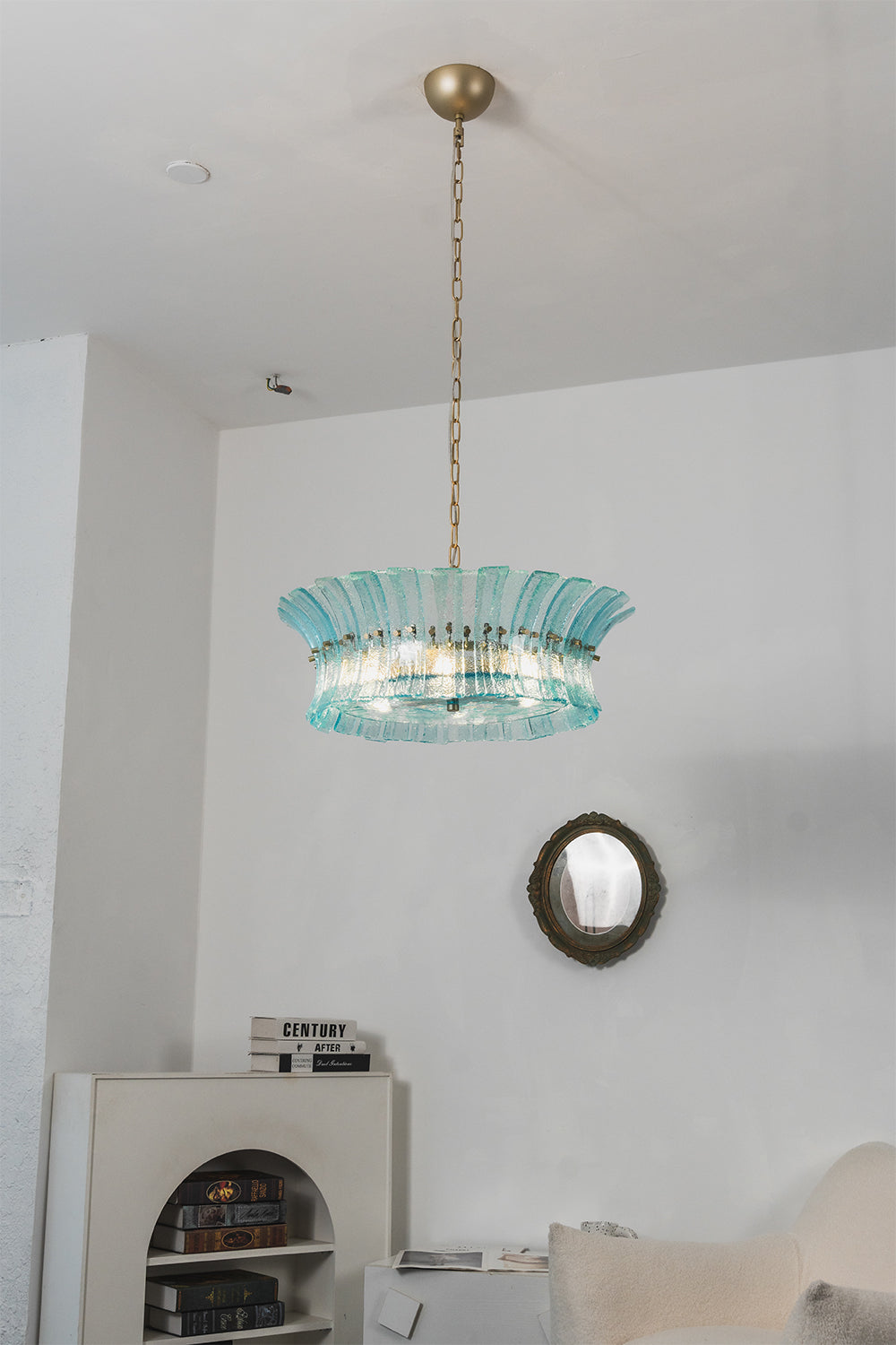 Thalassa Aquamarine Textured Glass Chandelier | Glass, Metal | Clean studio frontal view of the fully illuminated tiered ocean blue glass pendant hanging gracefully against plain white walls | Samu Lamp