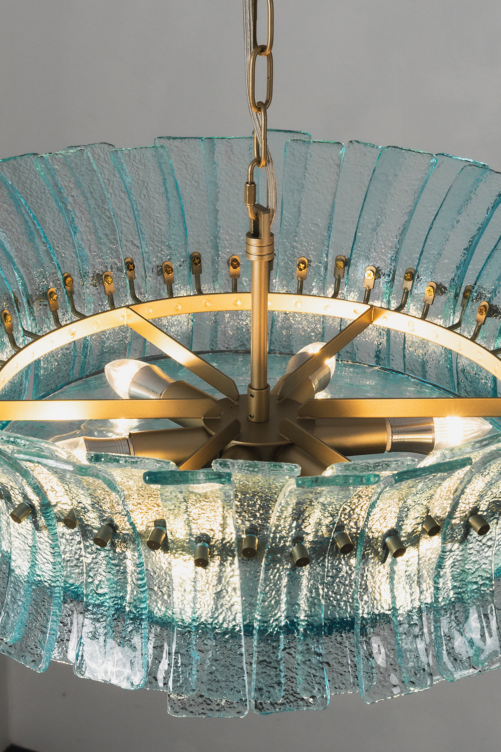 Thalassa Aquamarine Textured Glass Chandelier | Glass, Metal | Close-up internal view looking inside the radial gold brass frame core and light bulb sockets through the top ring | Detail shot | Samu Lamp