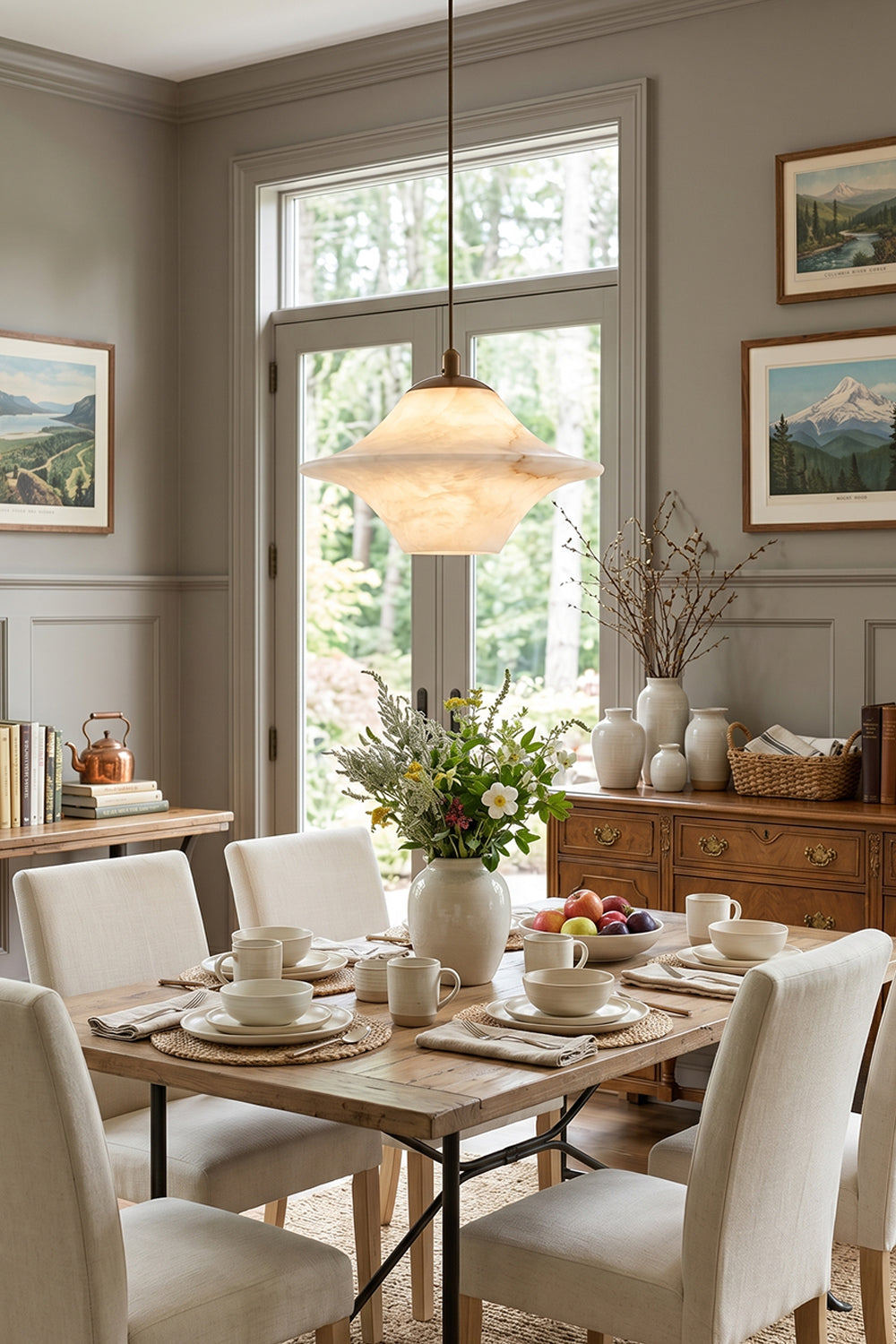 Thalia Alabaster Flared Pendant Light | Alabaster, Metal | Providing a warm golden glow above a wooden dining table paired with white upholstered chairs in a refined transitional dining room | Samu Lamp