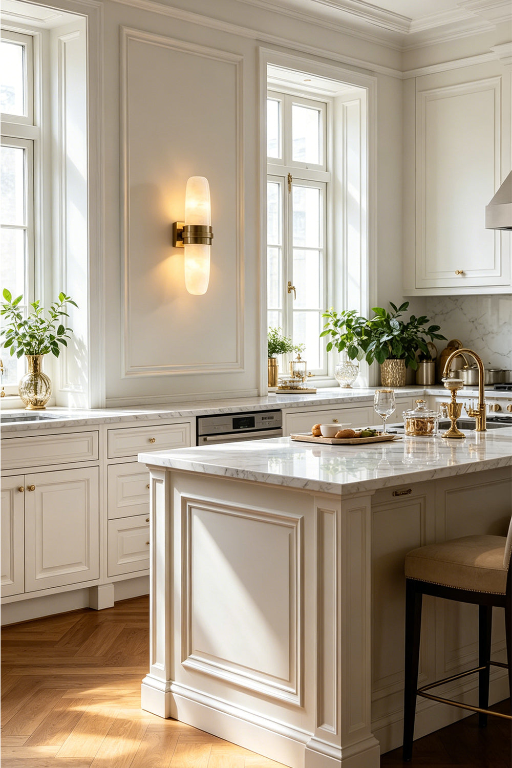 Theron Linear Alabaster Wall Lamp | Alabaster, Metal | Mounted on a white wall in a bright luxury kitchen area near a pristine white marble island counter | Samu Lamp