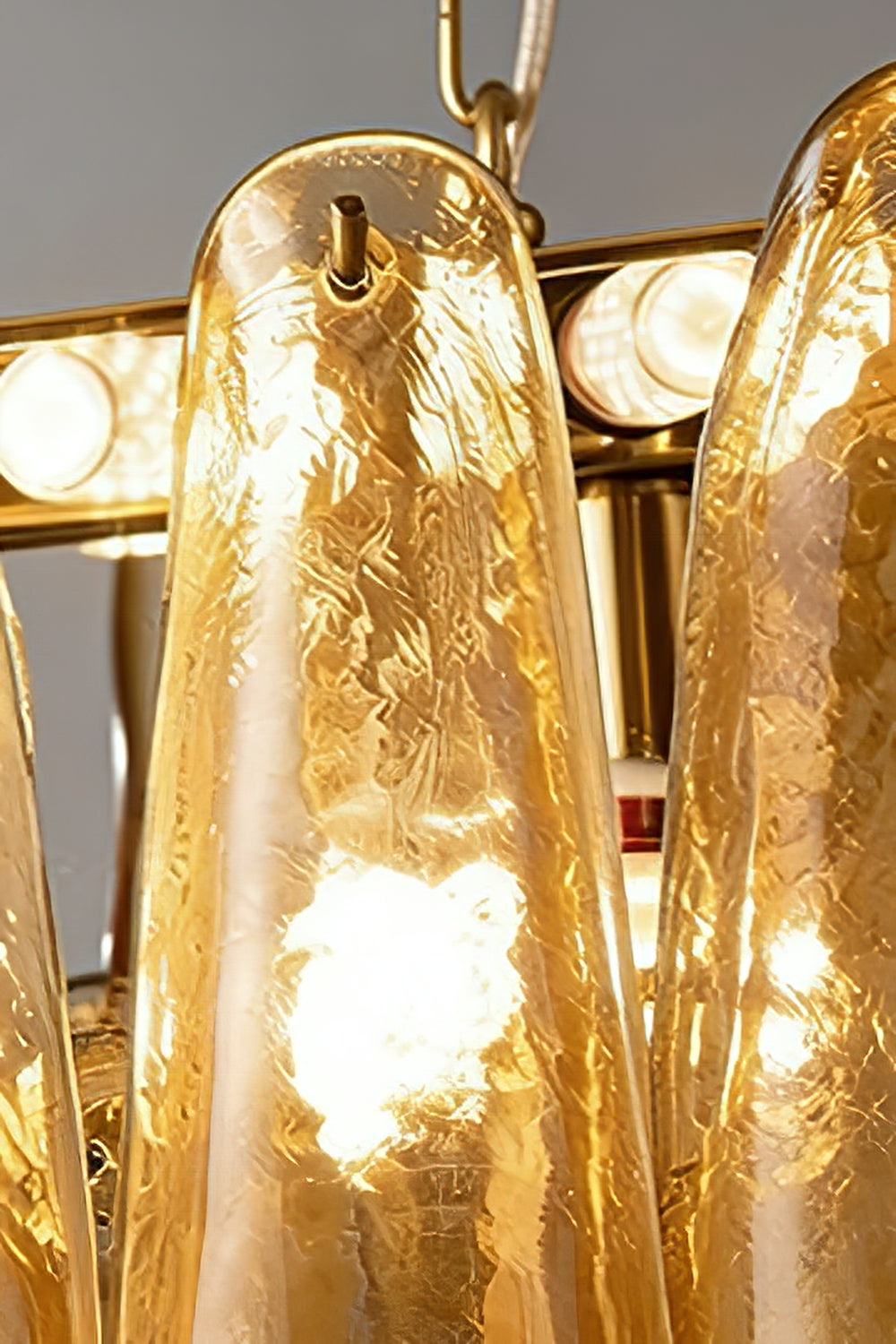 Close-up of metal frame and lily glass attachment | Metal, Glass | Showing the gold-finish hardware and glass hooks | Samu Lamp