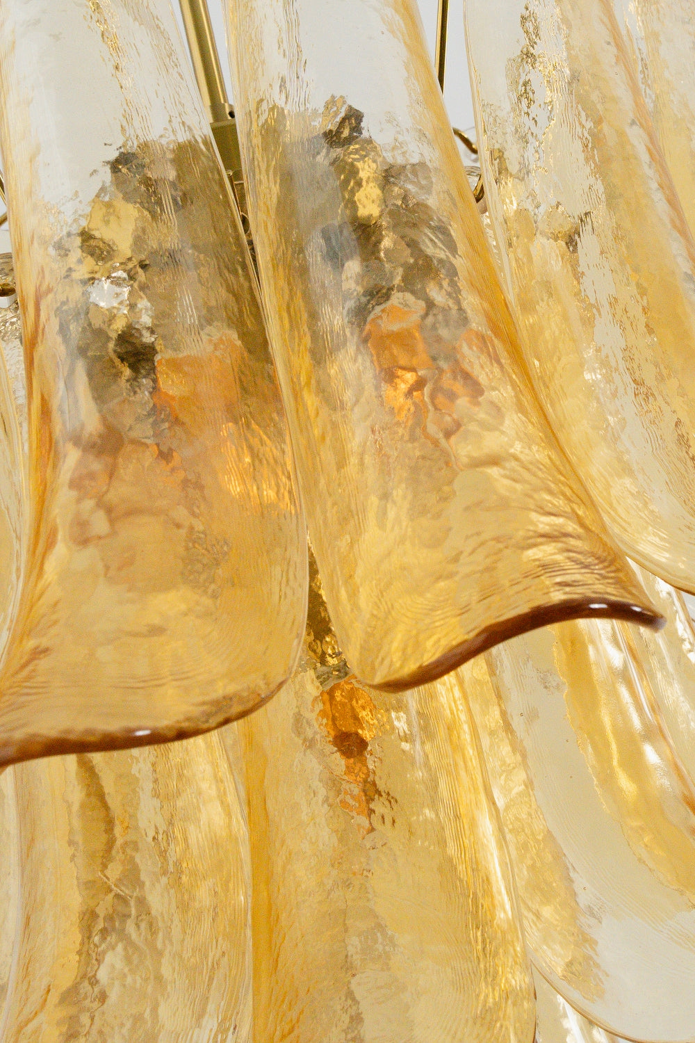 Macro texture of amber lily glass petals | Glass | Close-up showing the rippled finish and warm glow | Samu Lamp
