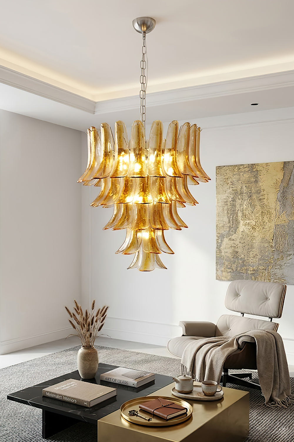 Tiered amber glass chandelier in living room | Metal, Glass | Interior scene with grey armchair and marble coffee table | Samu Lamp