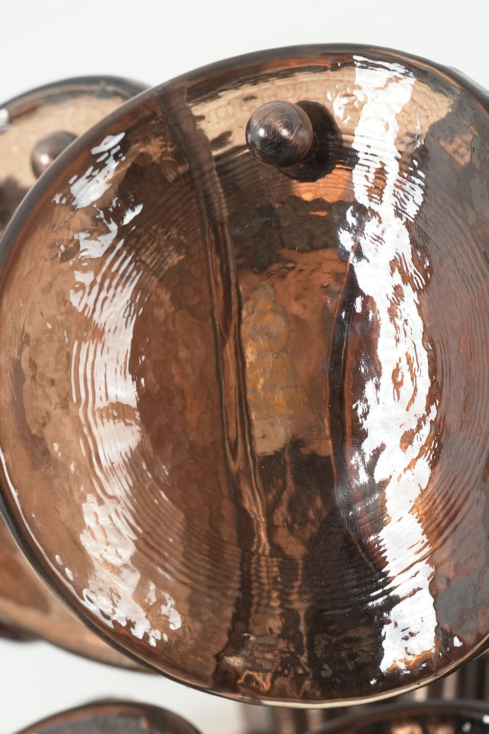 Tisanne Tiered Glass Disc Wall Lamp | Smoked Glass and Metal | Macro close-up shot showing the textured organic edge of a smoked glass disc | Samu Lamp