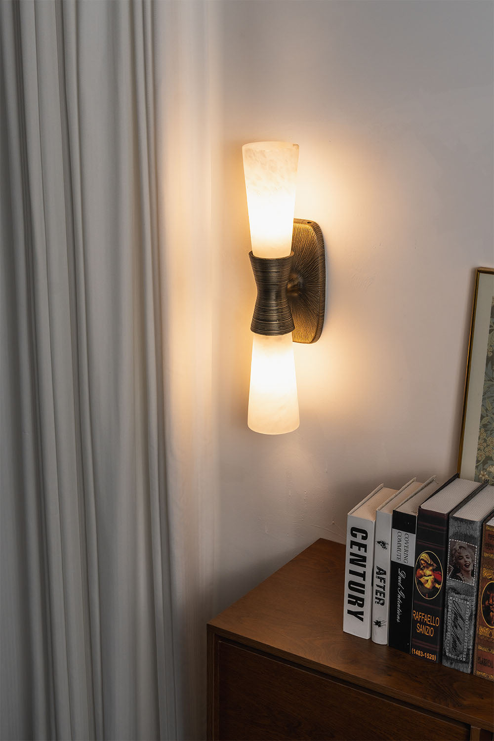Torsanne Wall Sconce | Alabaster and Bronze | Two-light model illuminated in room corner near drapes | Samu Lamp