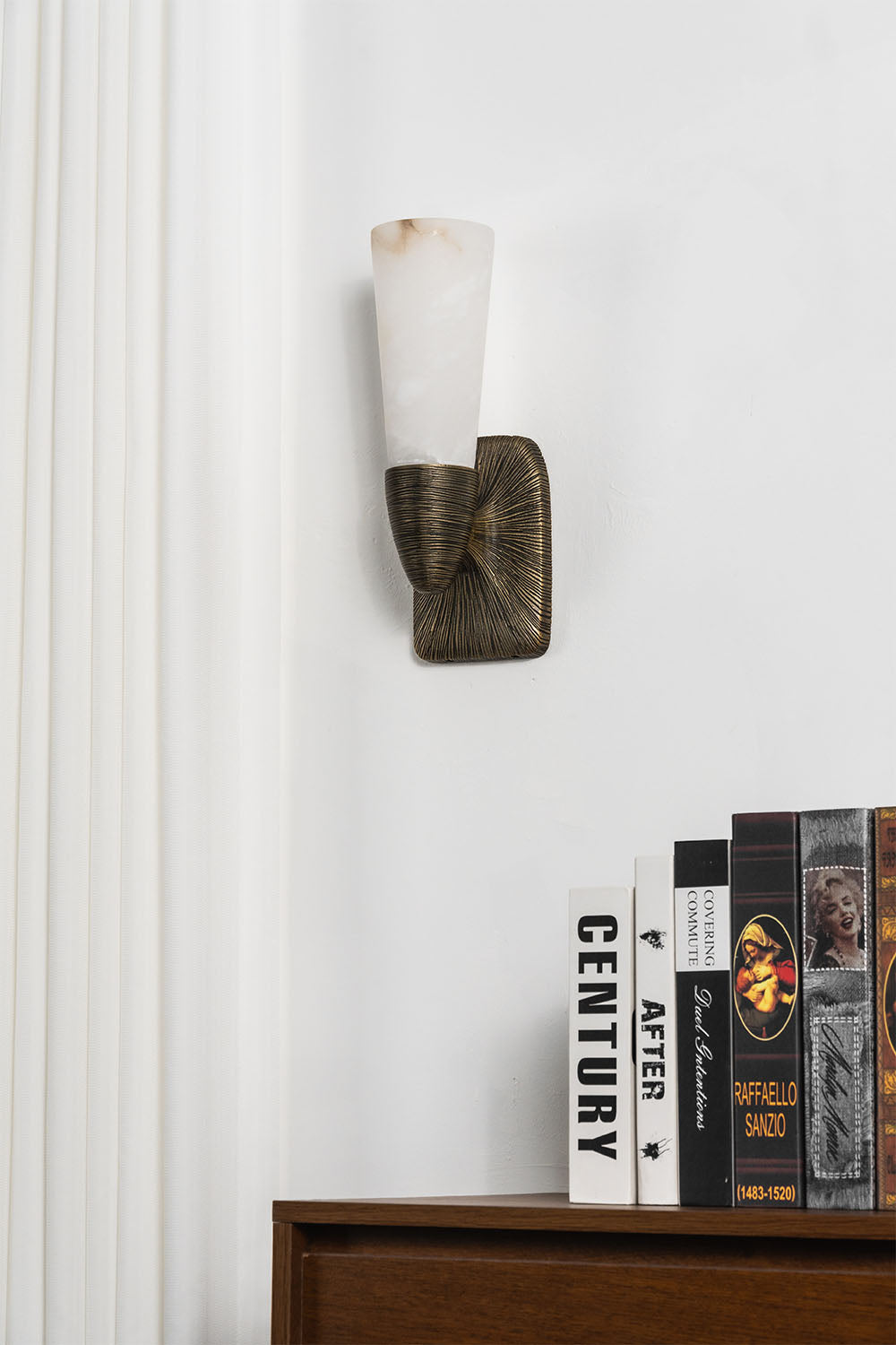 Torsanne Wall Sconce | Alabaster and Bronze | Single-light sconce unlit above credenza showing stone | Samu Lamp