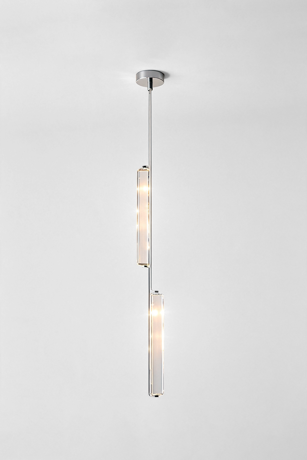 Torvald Crystal Bar Drop Pendant Light hanging from the ceiling, showcasing its sleek and modern design with elegant glass accents.