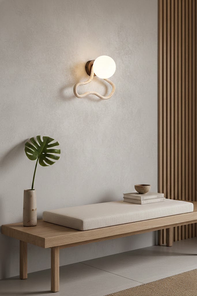 Travertine flow sconce in a zen-inspired space | Travertine, Glass, Wood | Above a wooden bench on a textured wall | Samu Lamp