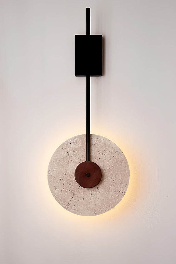Lit travertine halo wall sconce close-up | Travertine, Wood, Metal | Showing the warm light ring and black hardware | Samu Lamp