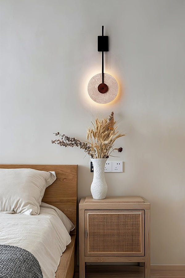 Travertine halo wall light as a bedside lamp | Travertine, Wood, Metal | Mounted above a light wood nightstand | Samu Lamp