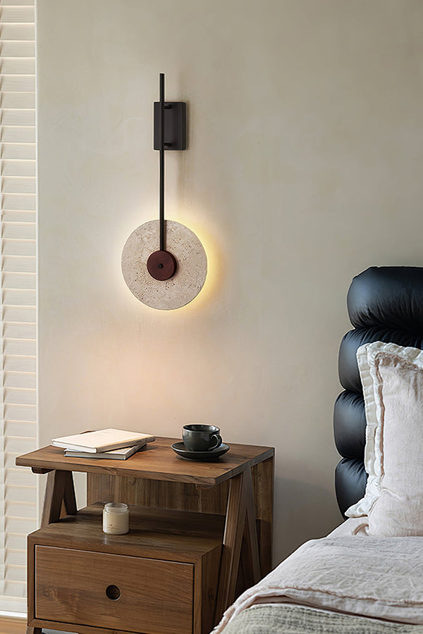 Modern travertine sconce in a luxury bedroom | Travertine, Wood, Metal | Next to a black leather headboard | Samu Lamp