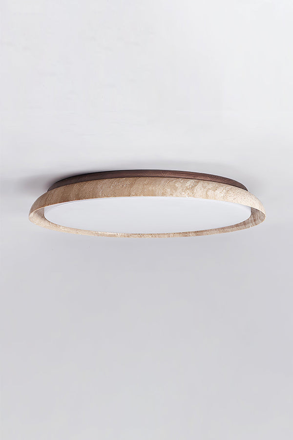 Lit round travertine flush mount lamp against white ceiling | Wood, Travertine, Acrylic | Showing the warm glow and natural stone grain | Samu Lamp