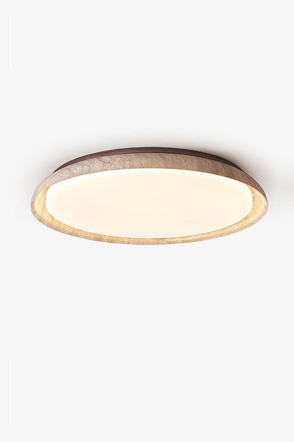 Lit round travertine flush mount lamp against white ceiling | Wood, Travertine, Acrylic | Showing the warm glow and natural stone grain | Samu Lamp