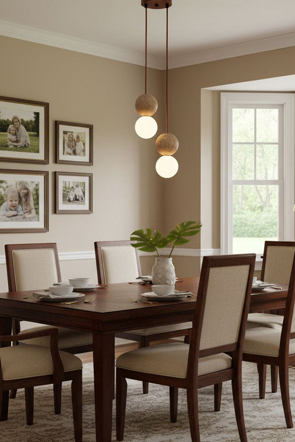 Pair of travertine stone pendants in a corner | Yellow Travertine, Glass | Traditional dining room scene with wooden furniture | Samu Lamp