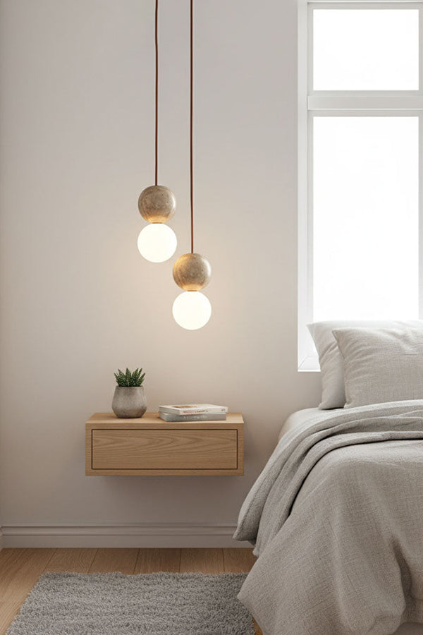 2-light cluster travertine bedside pendant | Yellow Travertine, Glass | Installed over a floating wooden nightstand | Samu Lamp