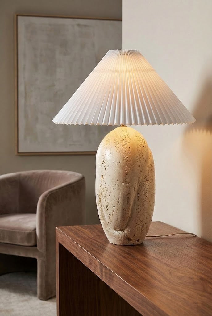 Lit travertine table lamp with warm glow | Travertine, Fabric | Side view on a wooden console table | Samu Lamp