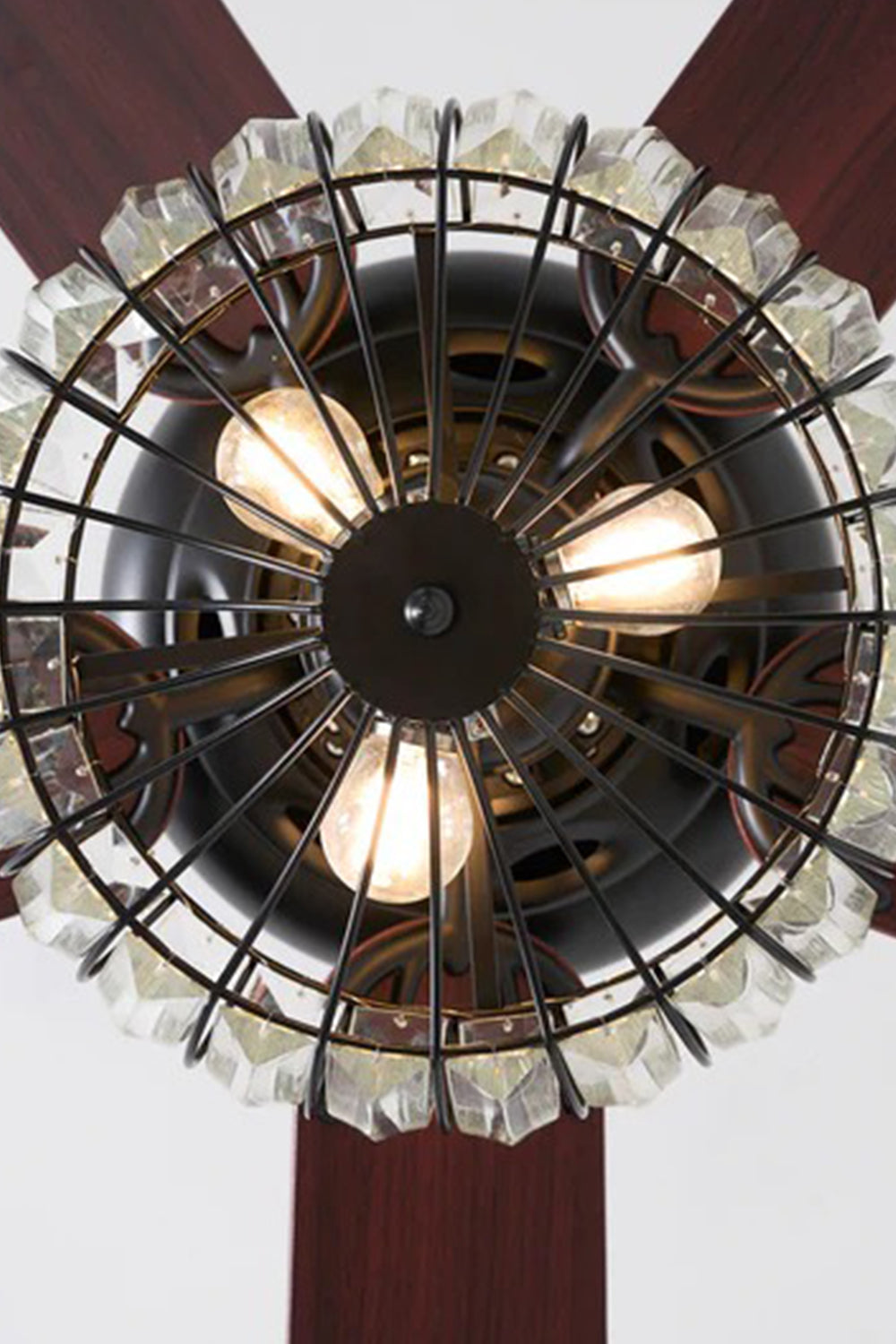 Valerius Luxury Crystal Ceiling Fan Light | Crystal, Metal, Wood | Bottom-up perspective looking into the illuminated wire basket cage housing three warm candle-style light bulbs | Detail shot | Samu Lamp