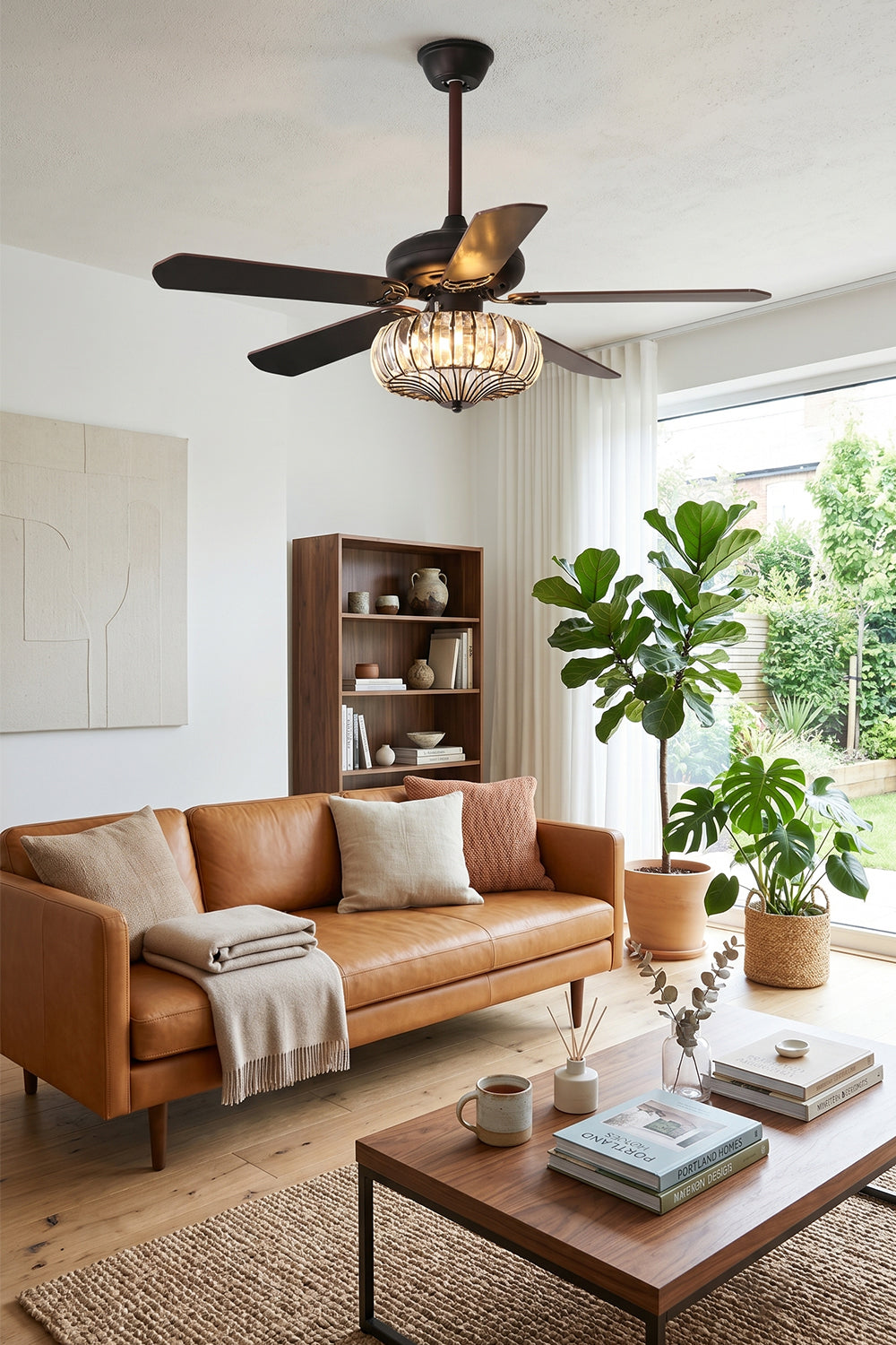 Valerius Luxury Crystal Ceiling Fan Light | Crystal, Metal, Wood | Installed as a functional statement fixture in a cozy living room with a brown leather sofa and large bright windows | Samu Lamp