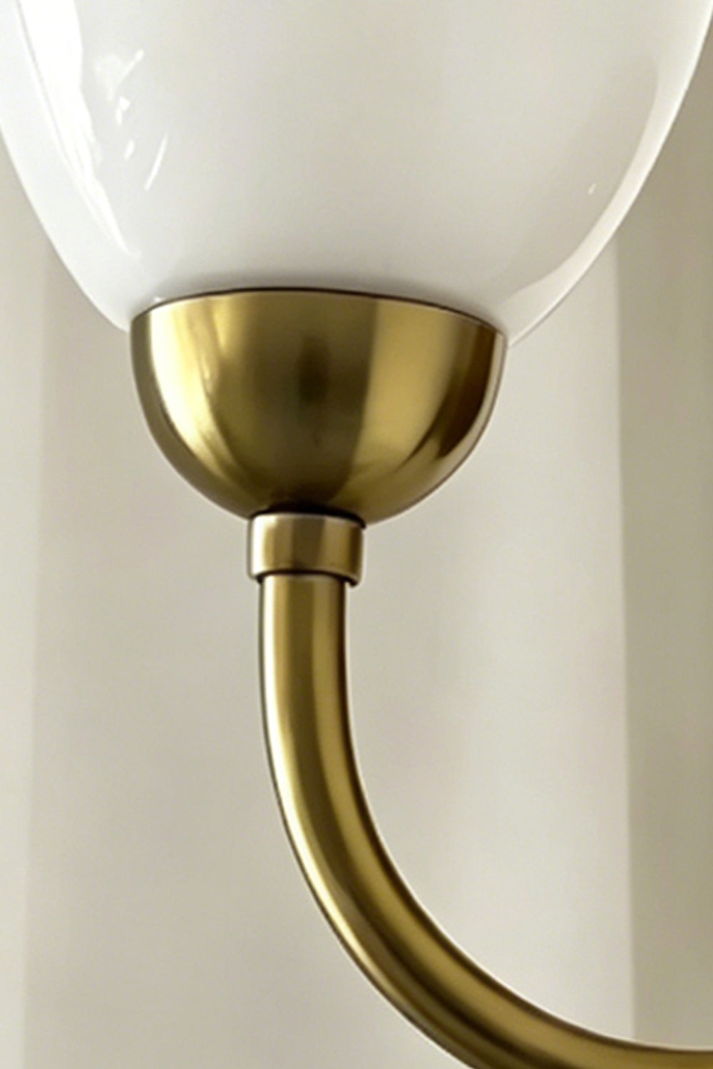 Close-up of Veil Curve Glass Wall Lamp | Metal, Glass | Detail shot focusing on brass base and opaque white glass shade | Samu Lamp