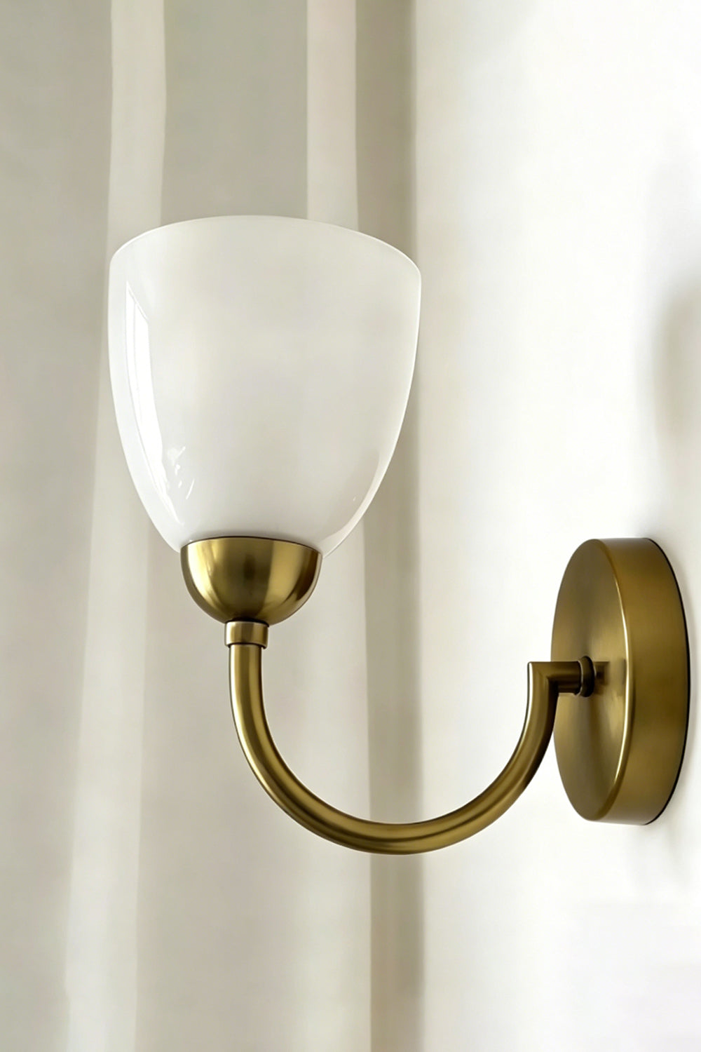 Veil Curve Glass Wall Lamp with white shade | Metal, Glass | Detail shot of white shade profile against light wall | Samu Lamp