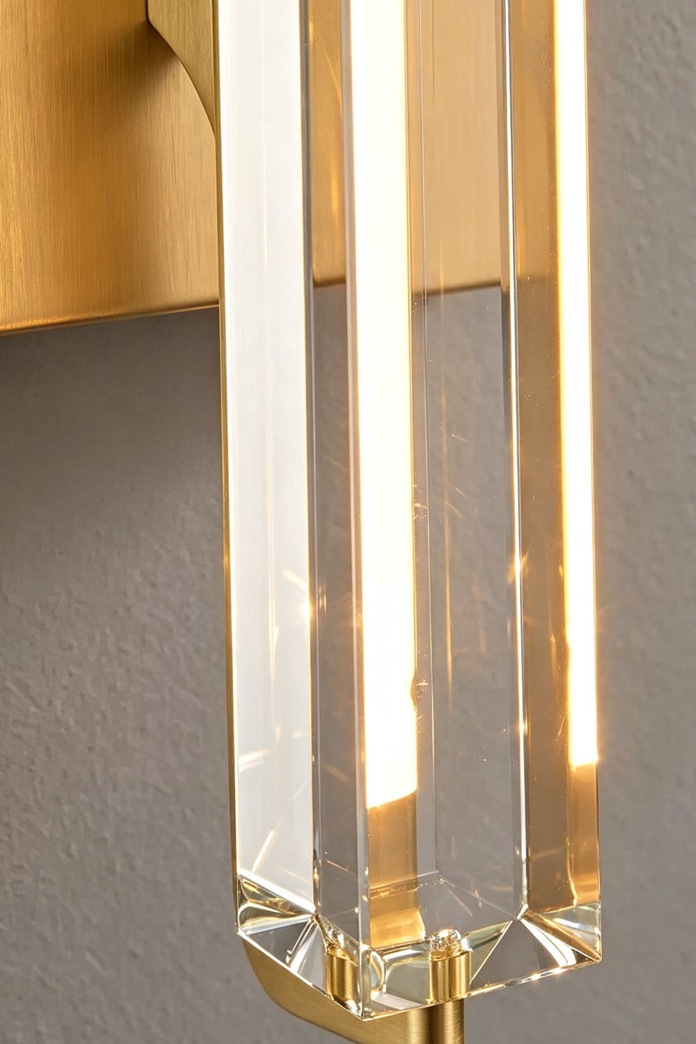 Close-up of Verel Crystal Bar Wall Sconce featuring clear crystal and warm LED light reflections.