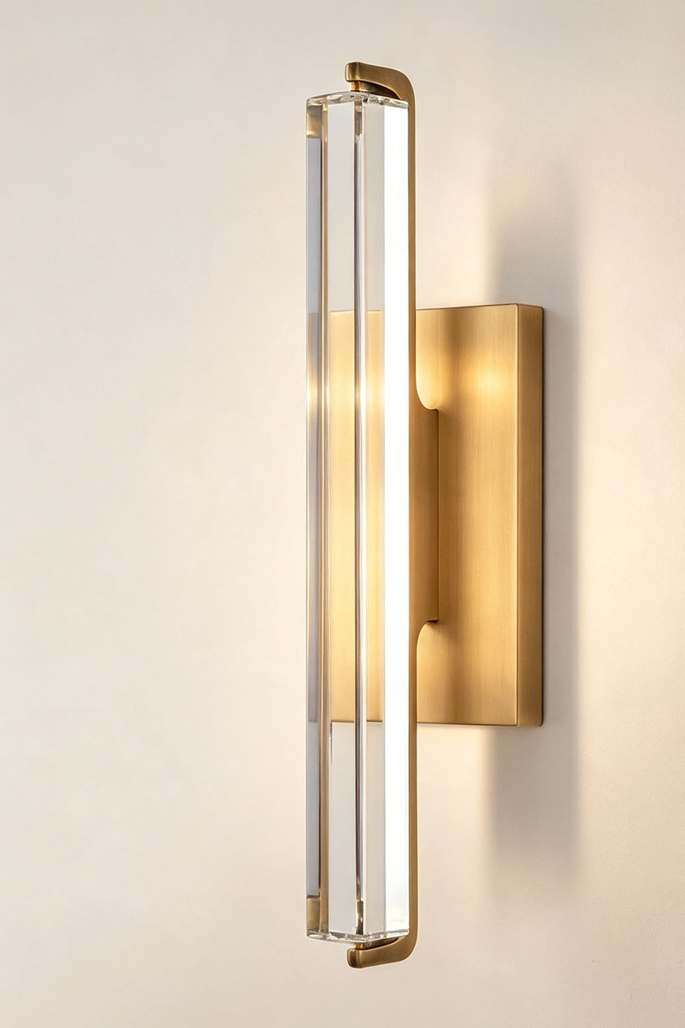 Verel Crystal Bar Wall Sconce featuring clear crystal and brass frame with warm LED light.