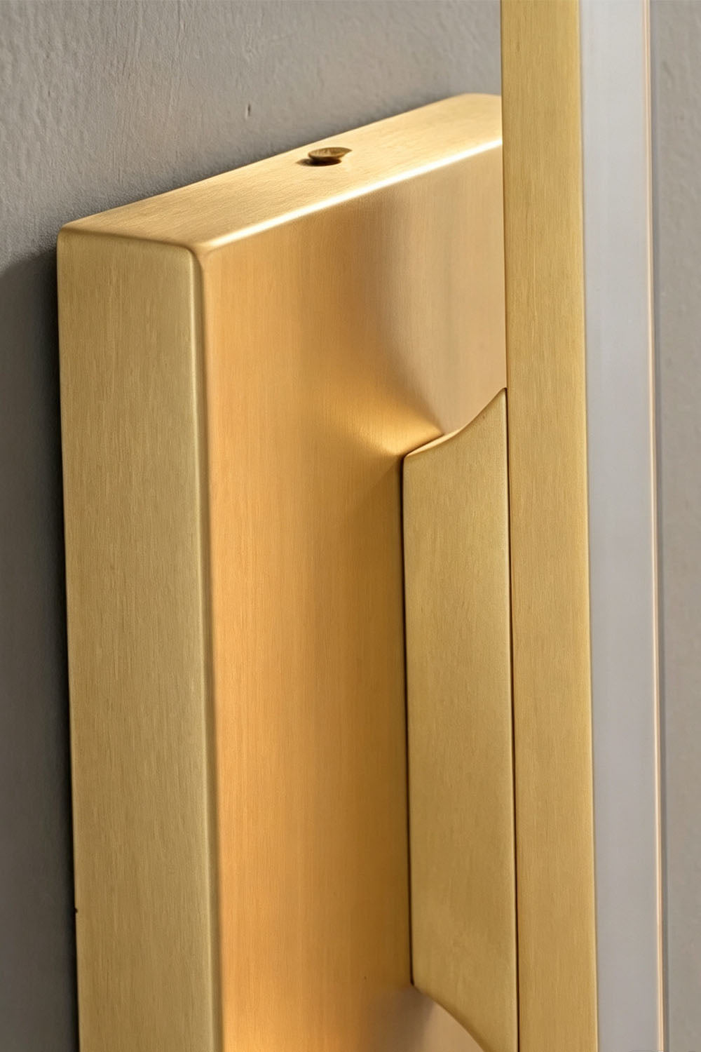 Close-up of Verel Crystal Bar Wall Sconce's brass backplate detail.